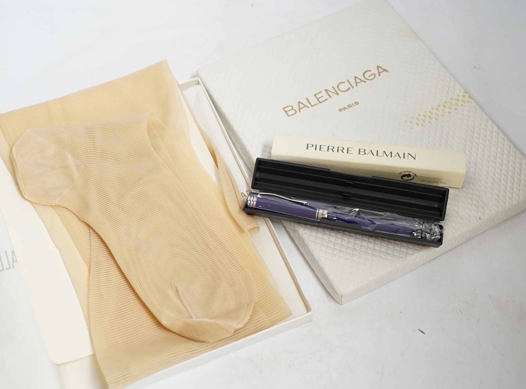 A pair of Balenciaga boxed stockings, size 10.5 and a boxed Pierre Balmain pen. Condition - good